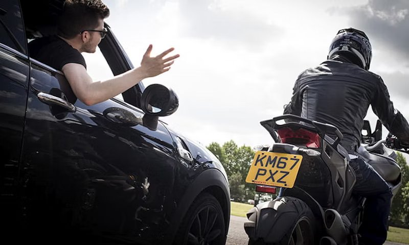 1714516490-biker-passing-car-rear