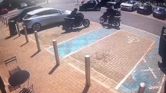 He tries to make a hasty getaway, pushing it out of the carpark with an escort of mopeds